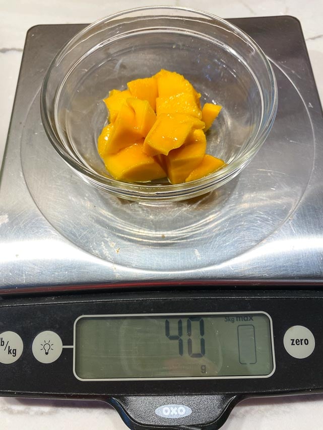 40 g of mango on scale in small dish