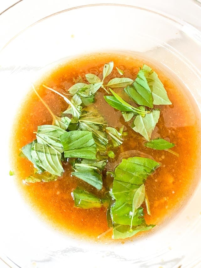 adding Thai basil to vinaigrette adding Thai basil to vinaigrette