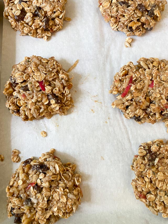 Apple oat breakfast cookie batter doled out onto parchment lined pan; gently pressed to even thickness