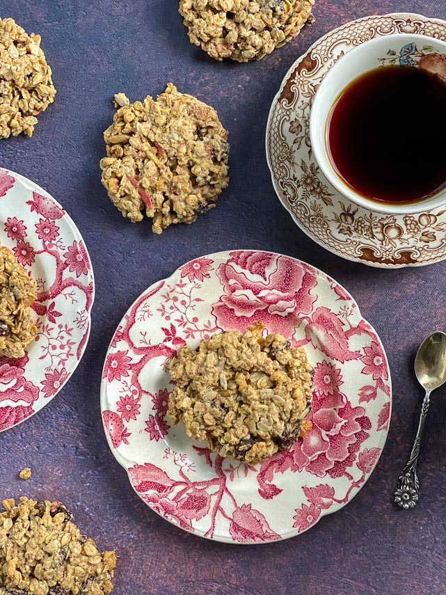 Low FODMAP Apple Oat Breakfast cookies on pink and white decorative plates; coffee and roses alongside