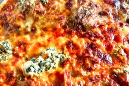 closeup of Baked low FODMAP Sheet Pan Lasagna with sausage on pan.