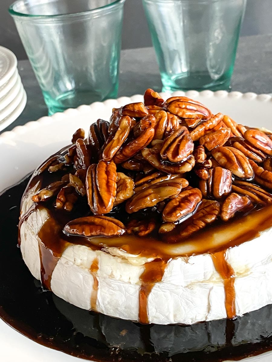 closeup of Low FODMAP Kahlua Pecan Brown Sugar Baked Brie on a platter