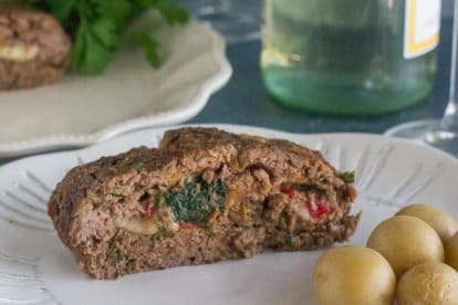 closeup of stuffed meatloaf on white plate