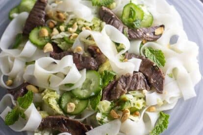 closeup-overhead-of-Asian-Steak-and-Noodle-salad-on-white-plate.