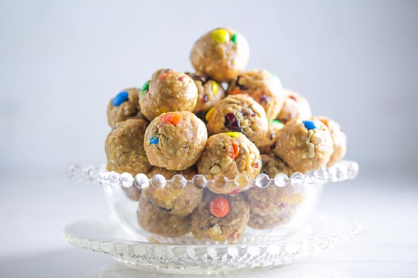 closeup side view of low FODMAP Trail Mix Energy Balls in clear glass dish
