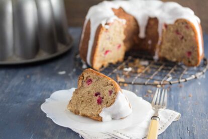 cranberry bundt cake slice on a white antique plate