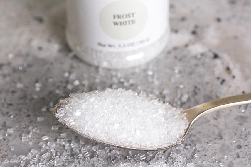 All About Sugar. Crystal sugar on a spoon