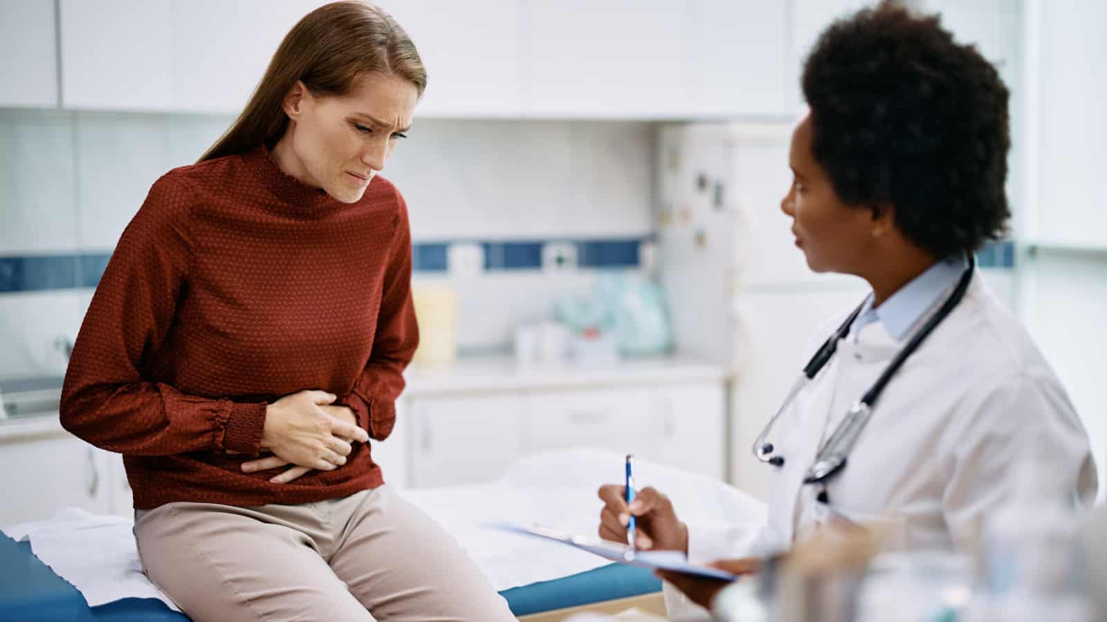 Female-patient-female-doctor-pain-in-abdomen.-