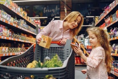 Mother and young girl grocery shopping.