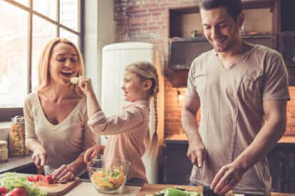 Happy family cooking and eating.