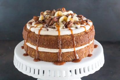 horizontal image of low FODMAP Salted Caramel Banana Cake on white pedestal