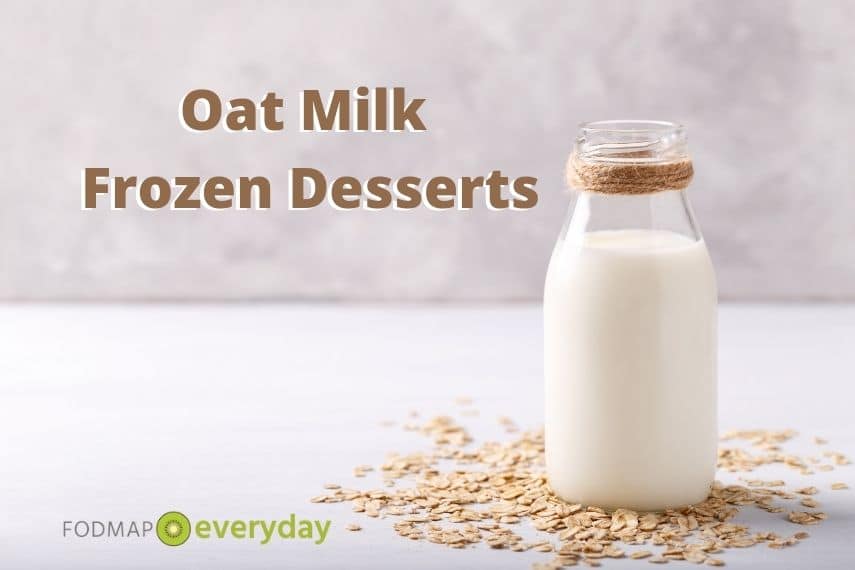 a side shot of a glass milk bottle filled with oat milk with oats scattered around it 