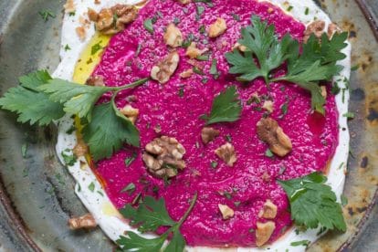 Beet Yogurt Dip with Walnuts on a rustic platter