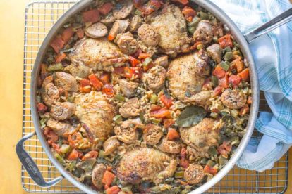 chicken and sausage jambalaya overhead in skillet with yellow background