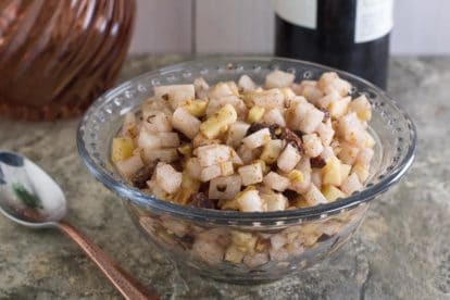 low FODMAP apple charoset with copper spoon in glass bowl