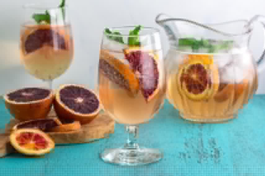Low FODMAP Blood Orange Ginger Mint Spritzer with pitcher in background
