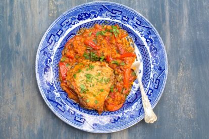 Low FODMAP Chicken & Lentils on a blue and white plate and blue painted background