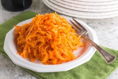Low FODMAP Grated Carrot Salad on white plate; green napkin underneath, white plates alongside-2