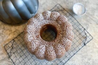 main image of Gluten-Free Low FODMAP Honey Cake on cooling rack, dusted with confectioners' sugar