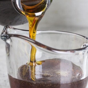 maple syrup pouring into a glass pitcher
