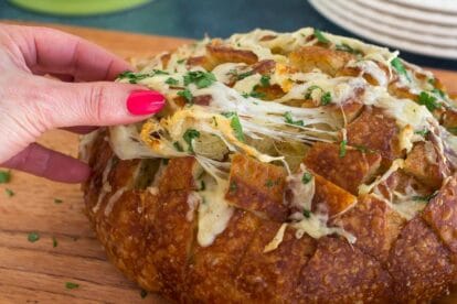 mega cheesy Low FODMAP Cheesy Pull Apart Bread on wooden board