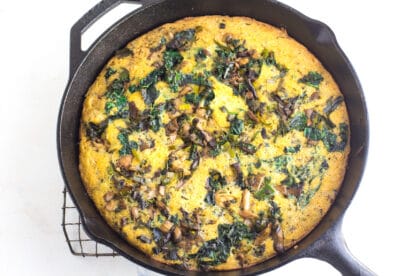 mushroom cornbread stuffing in cast iron skillet against white background