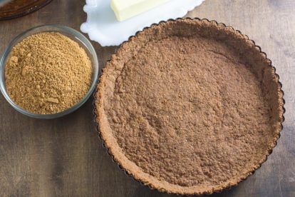 overhead image of a pre-baked low FODMAP crumb crust in a tart pan