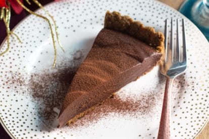 overhead image of slice of Low FODMAP Cinnamon Pecan Truffle Ganache Tart