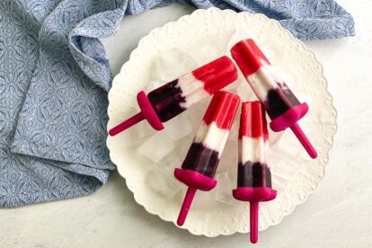 overhead image of vegan red, white and blue popsicles on white plate