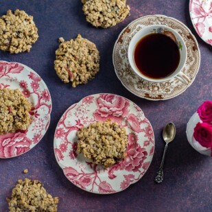 overhead-of-Low-FODMAP-Cinnamon-Apple-Breakfast-Cookies-on-pink-and-white-plates-cup-of-coffee-and-roses-in-background