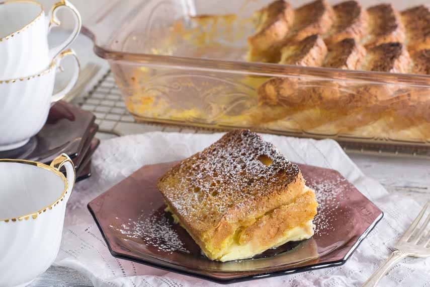overnight eggnog French Toast slice plated on amethyst colored glass plate