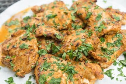platter of spiced yogurt grilled chicken garnished with cilantro