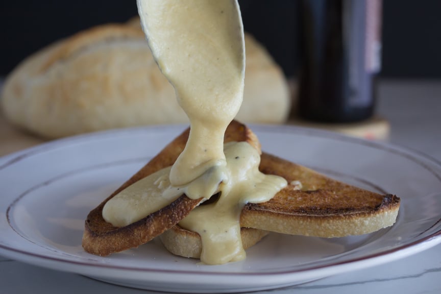 Welsh Rarebit generously poured over well toasted bread.