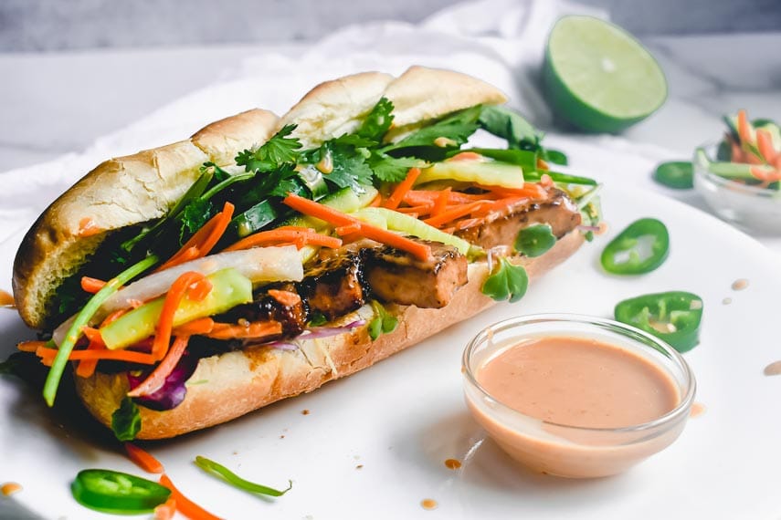 side view of Tofu Bánh Mì sandwich on white plate