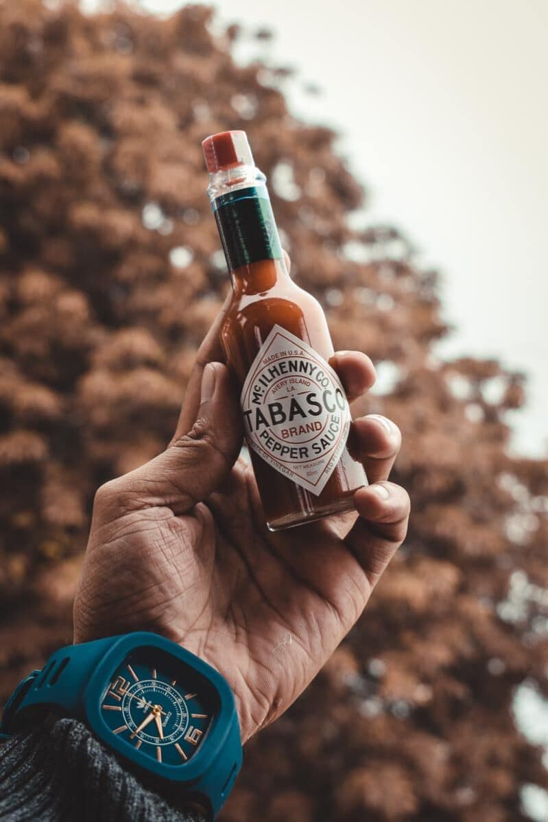 Tabasco bottle held in man's hand