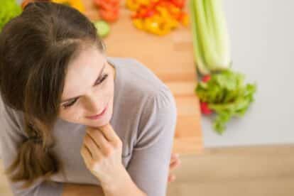 Thoughtful woman with food.