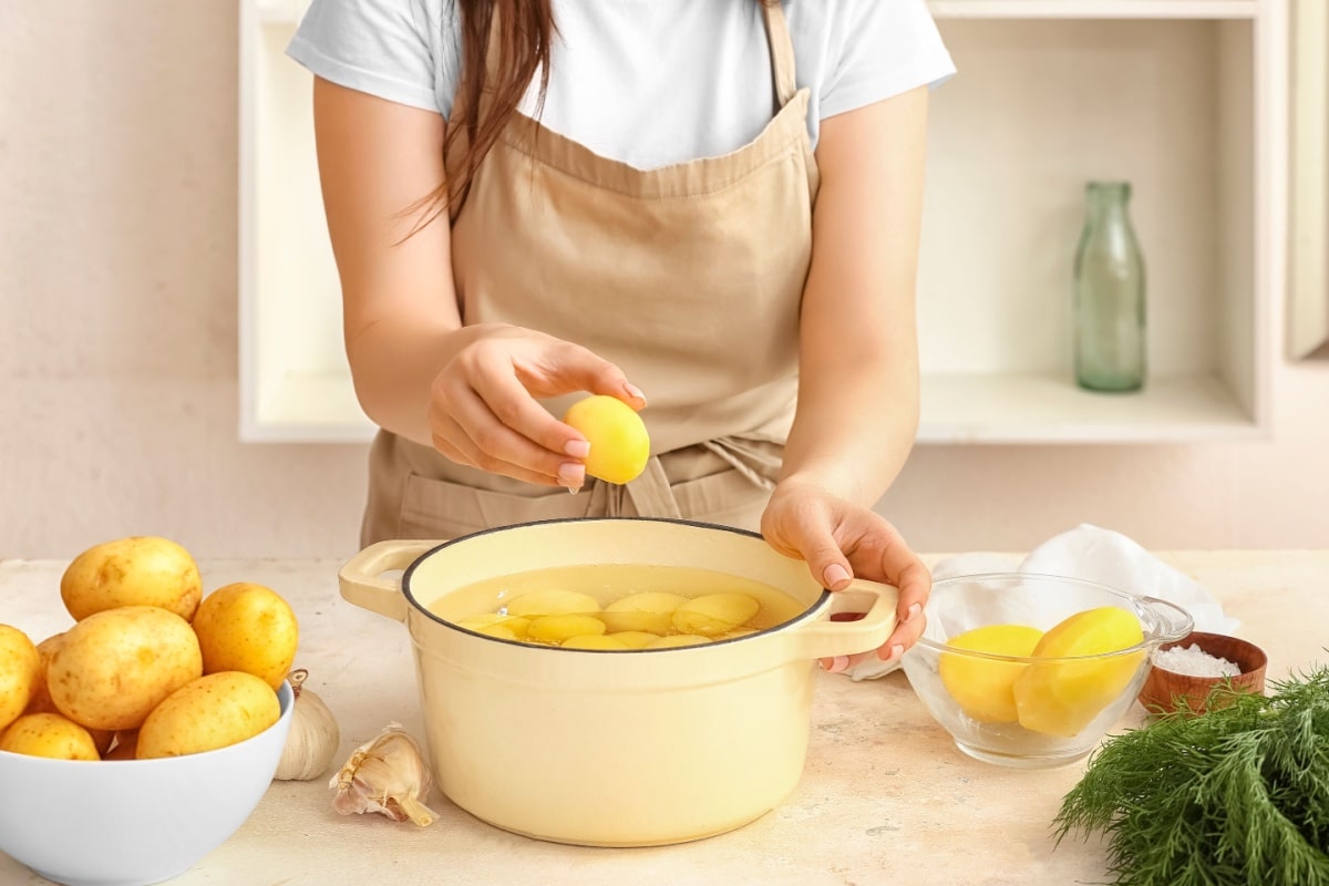 Woman boiling potatoes.