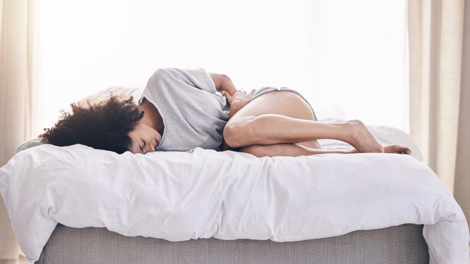 woman in pain clutching stomach. 
