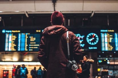 Young man looking at departure board